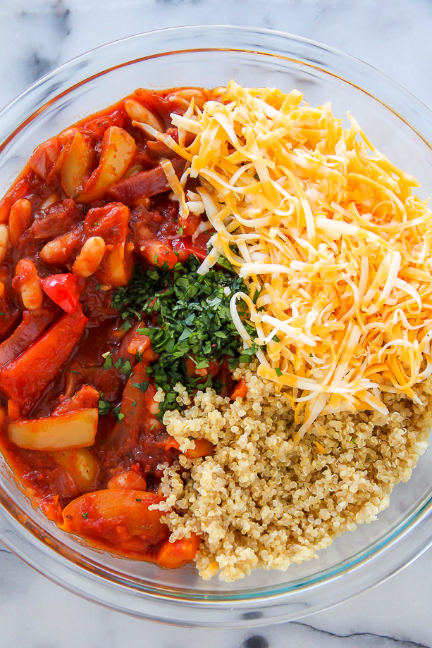 Quinoa, cheese, and vegetables in mixing bowl.