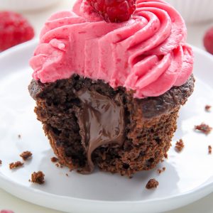 Decadent chocolate cupcakes stuffed with creamy nutella and topped with fresh raspberry frosting.