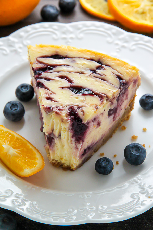 Supremely smooth and creamy homemade Lemon cheesecake topped with fresh Blueberry swirls. All layered on top of a buttery homemade graham cracker crust. 