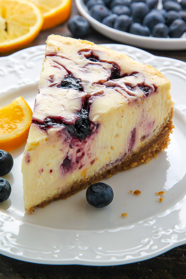 Supremely smooth and creamy homemade Lemon cheesecake topped with fresh Blueberry swirls. All layered on top of a buttery homemade graham cracker crust. 