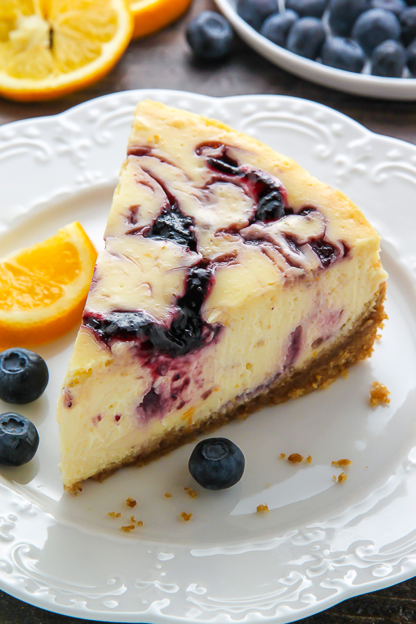 Supremely smooth and creamy homemade Lemon cheesecake topped with fresh Blueberry swirls. All layered on top of a buttery homemade graham cracker crust. 