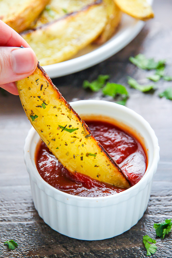 Extra crispy oven baked potato wedges flavored with garlic and herbs. Bet you can't eat just one!