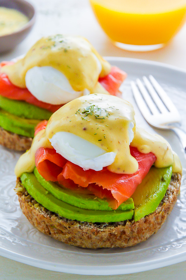 Smoked Salmon and Avocado Eggs Benedict on a white plate. 