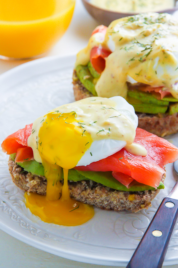 Smoked Salmon and Avocado Eggs Benedict with runny yolk.