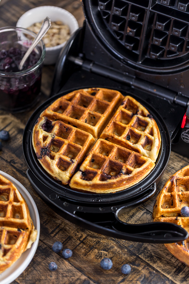 Homemade Greek Yogurt Blueberry Waffles topped with Fresh Blueberry Sauce. Fluffy, crispy, phenomenal.