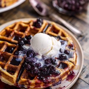 Homemade Greek Yogurt Blueberry Waffles topped with Fresh Blueberry Sauce. Fluffy, crispy, phenomenal.