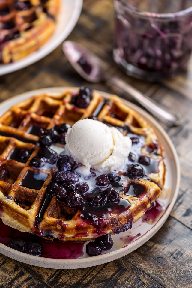 Homemade Greek Yogurt Blueberry Waffles topped with Fresh Blueberry Sauce. Fluffy, crispy, phenomenal.