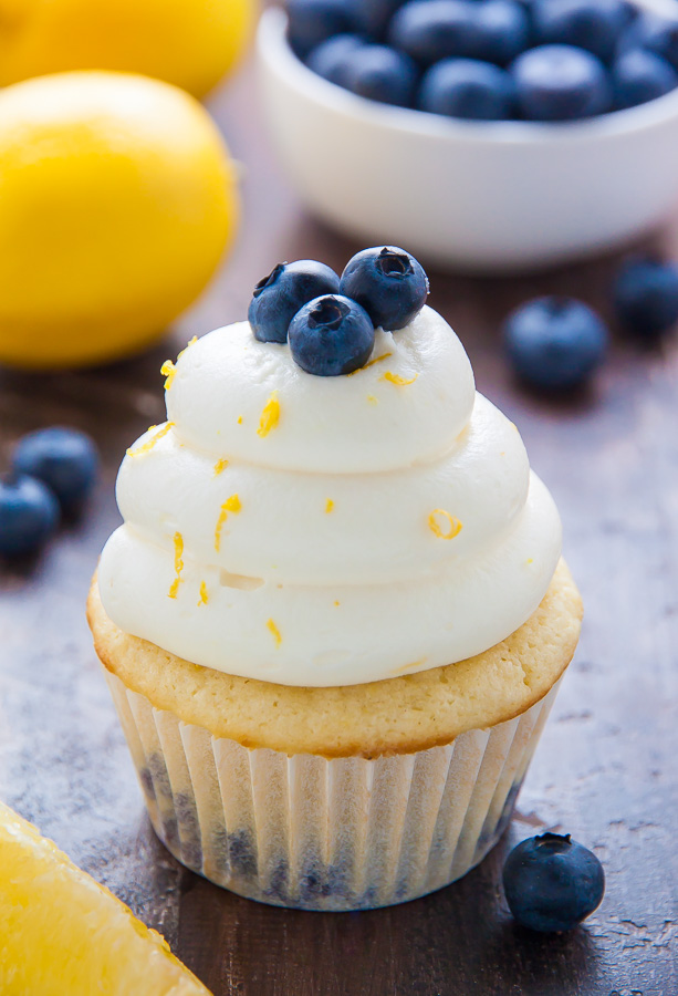Homemade Lemon Blueberry Cupcakes are topped with luscious Lemon Cream Cheese Frosting and Fresh Blueberries! The moist lemon cupcakes are so flavorful and bursting with juicy blueberries. This recipe is such a crowd-pleaser and perfect for Summer birthday parties, picnics, or barbecues! 