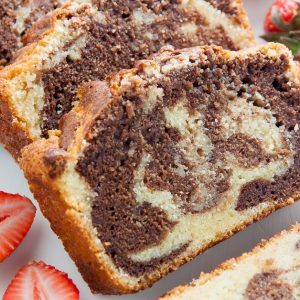 Supremely Moist Marble Pound Cake topped with juicy strawberries! This one's a keeper.