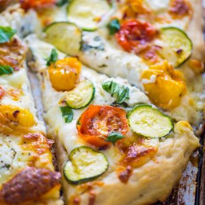 My favorite White Pizza with tomatoes, basil, and zucchini! AKA the PERFECT Summer meal.