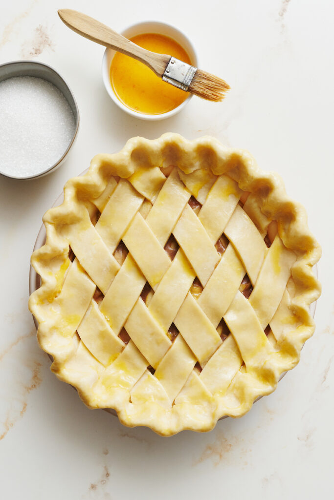 Apple pie with top crust and bottom crust, ready to be baked.