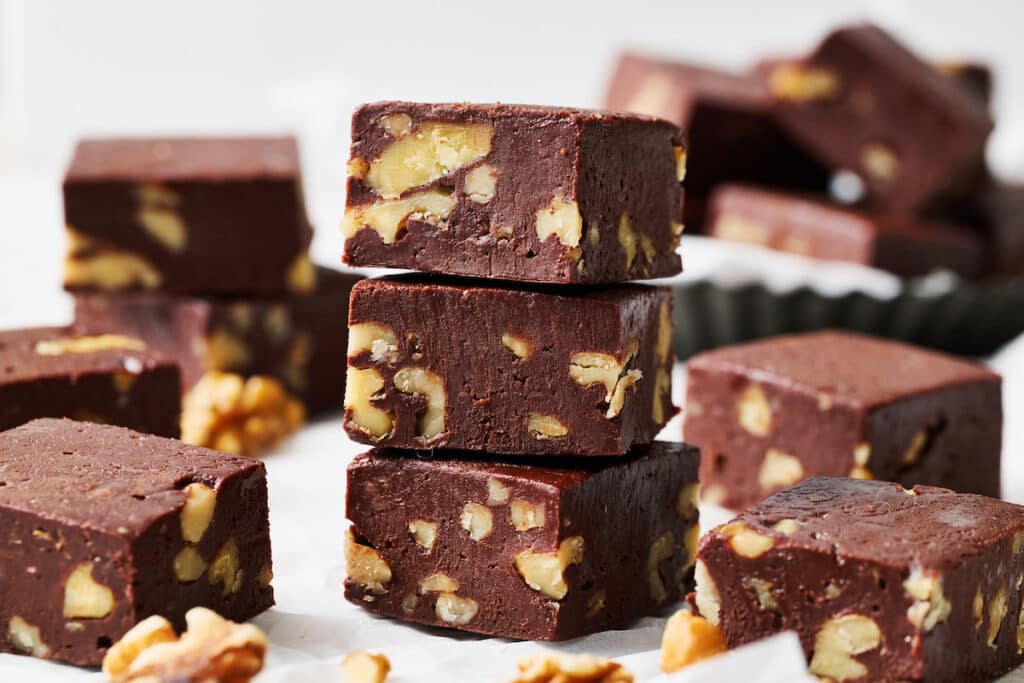 Chocolate fudge with walnuts in a stack .