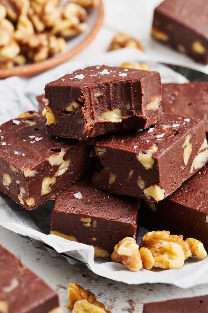 Chocolate fudge on a plate with a bite taken out.