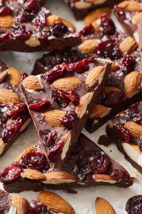 Chocolate bark cut into triangles on a white table.