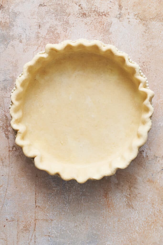 Pie dough in pie plate for Quiche Lorraine recipe.