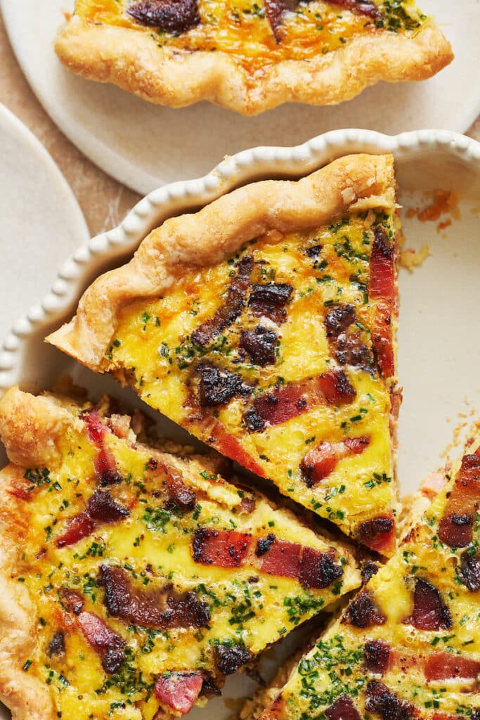 Slice of Quiche Lorraine in a pie plate.