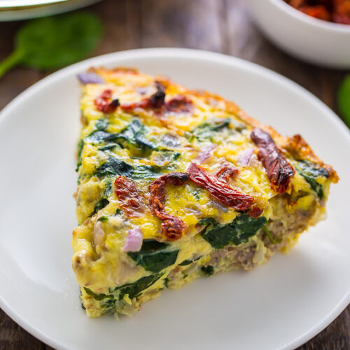 Easy and delicious, this healthier Crustless Quiche with Spinach, Sausage, and Sundried Tomatoes is perfect for brunch or dinner!