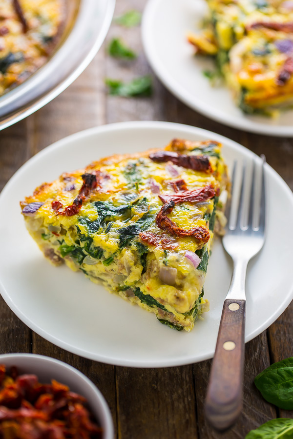 Easy and delicious, this healthier Crustless Quiche with Spinach, Sausage, and Sundried Tomatoes is perfect for brunch or dinner!