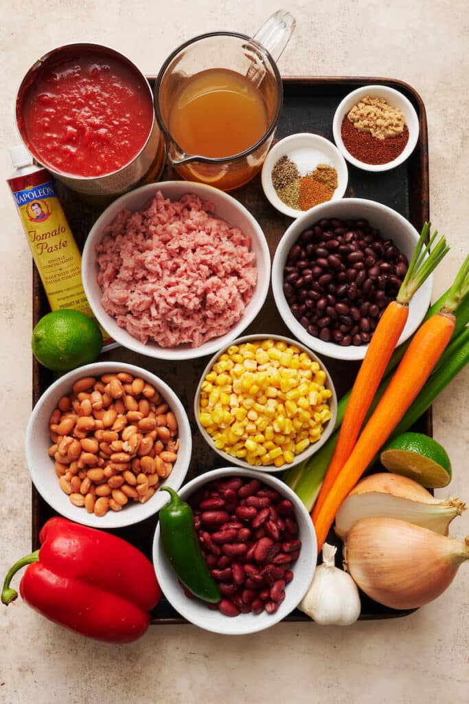 Ingredients for turkey chili including ground turkey, kidney beans, and chili powder. 