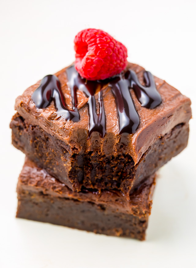 Raspberry Truffle Brownies feature a thick and chewy brownie base, chocolate raspberry frosting, and a chocolate drizzle!