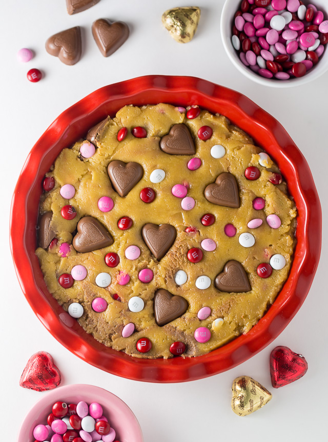 This deep dish Valentine's Day Cookie Pie is loaded with festive M&M's and Heart Shaped Peanut Butter Cups!