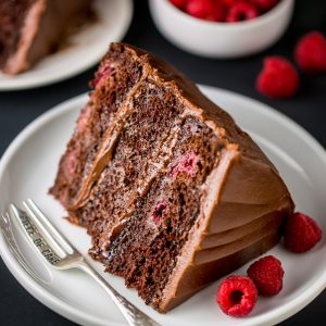 This Triple Layer Chocolate Raspberry Cake is a SHOWSTOPPER! Top with fresh raspberries for an extra lovely presentation.