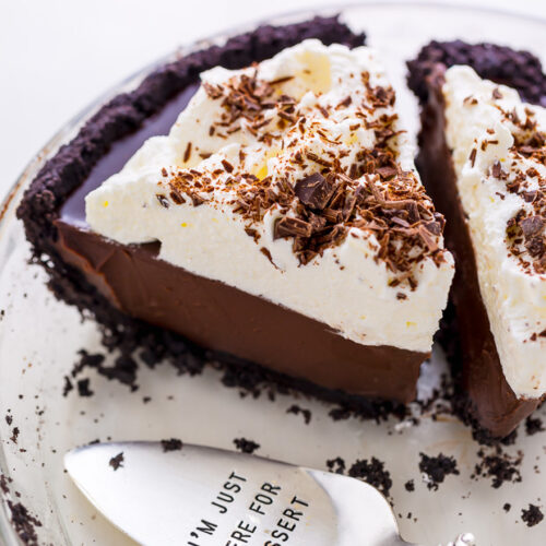Chocolate cream pie in baking dish with server.