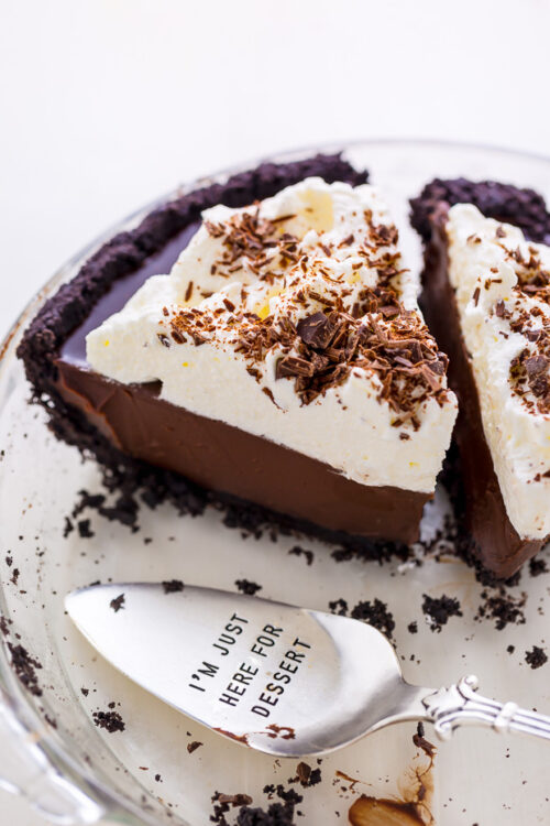 Chocolate cream pie in baking dish with server.