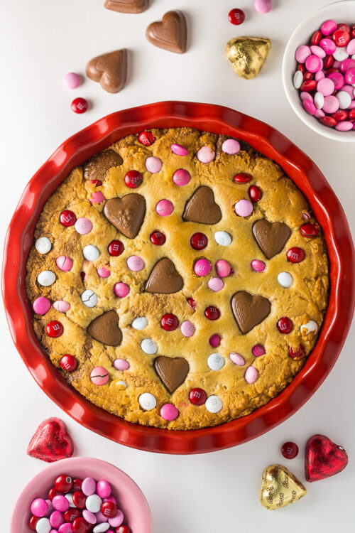 This deep dish Valentine's Day Cookie Pie is loaded with festive M&M's and Heart Shaped Peanut Butter Cups!