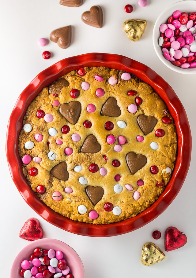 This deep dish Valentine's Day Cookie Pie is loaded with festive M&M's and Heart Shaped Peanut Butter Cups!