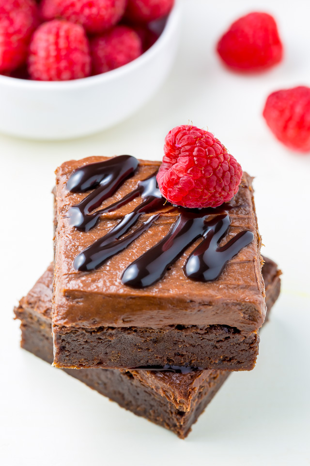 Raspberry Truffle Brownies feature a thick and chewy brownie base, chocolate raspberry frosting, and a chocolate drizzle!