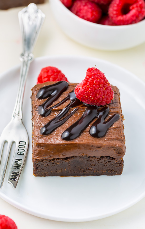 Raspberry Truffle Brownies feature a thick and chewy brownie base, chocolate raspberry frosting, and a chocolate drizzle!