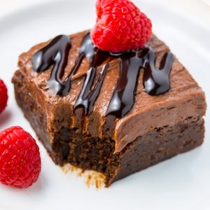 Raspberry Truffle Brownies feature a thick and chewy brownie base, chocolate raspberry frosting, and a chocolate drizzle!