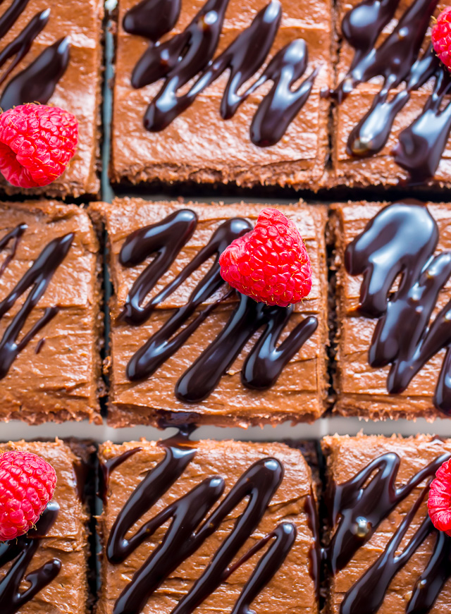 Raspberry Truffle Brownies feature a thick and chewy brownie base, chocolate raspberry frosting, and a chocolate drizzle!