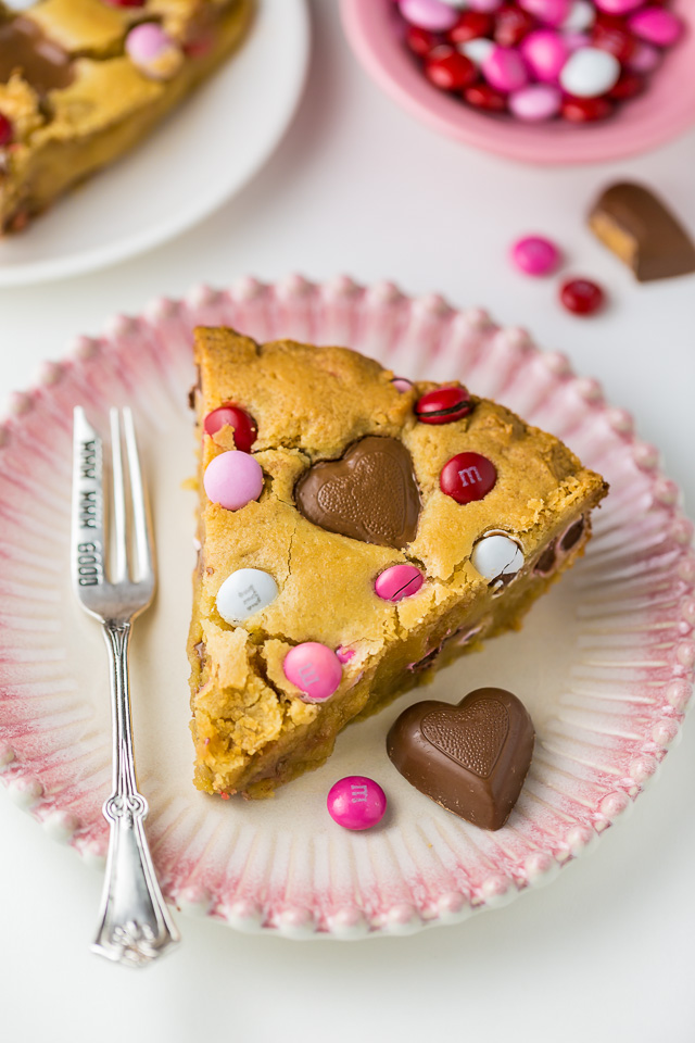 This deep dish Valentine's Day Cookie Pie is loaded with festive M&M's and Heart Shaped Peanut Butter Cups!