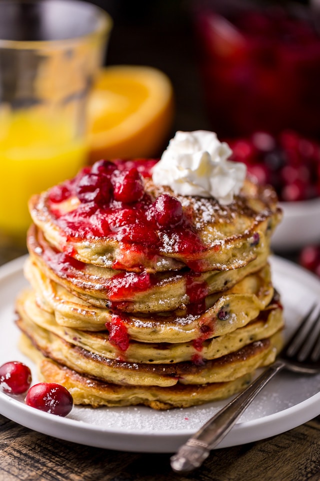 Fluffy and flavorful Cranberry Orange Pancakes are topped with Maple Cranberry Syrup!