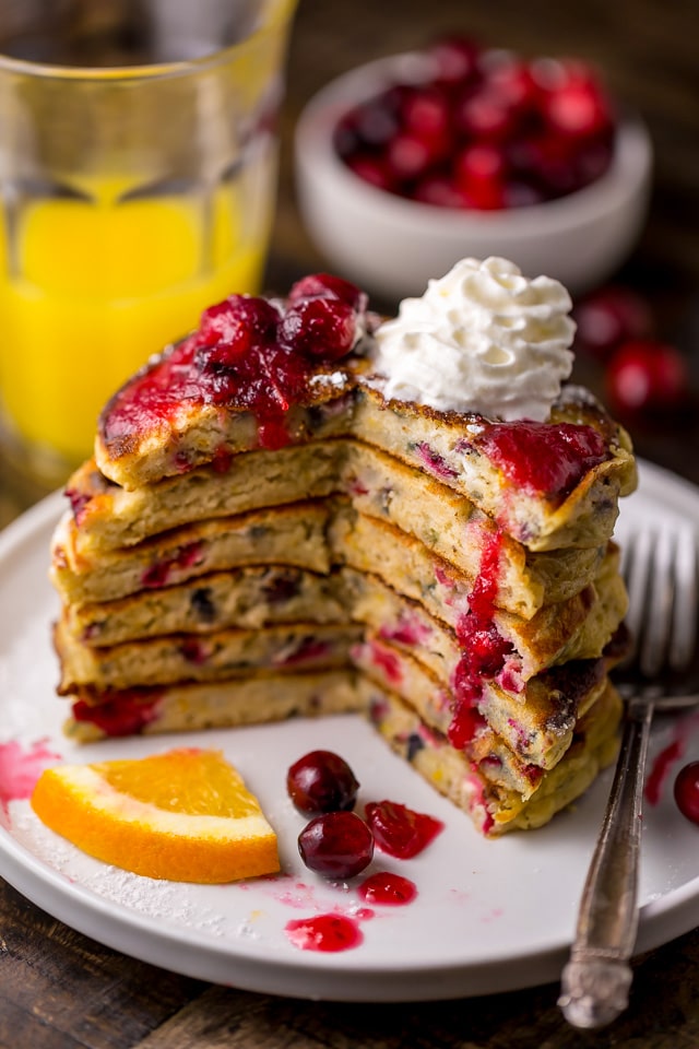 Fluffy and flavorful Cranberry Orange Pancakes are topped with Maple Cranberry Syrup!