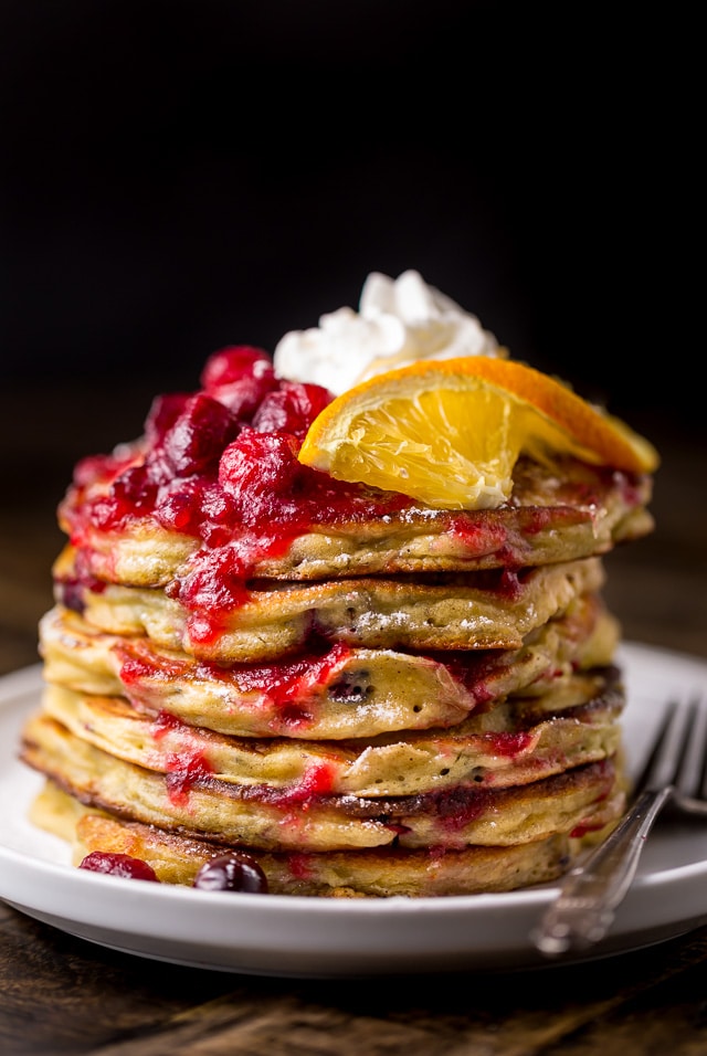Fluffy and flavorful Cranberry Orange Pancakes are topped with Maple Cranberry Syrup!