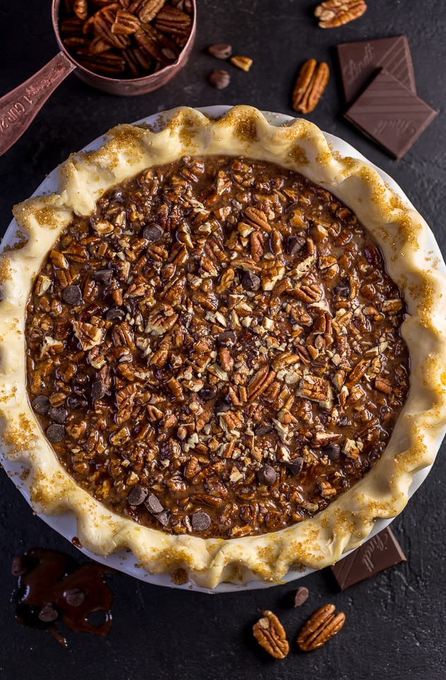This insanely decadent Chocolate Pecan Pie is topped with a dollop of whipped cream... and extra chocolate, of course!