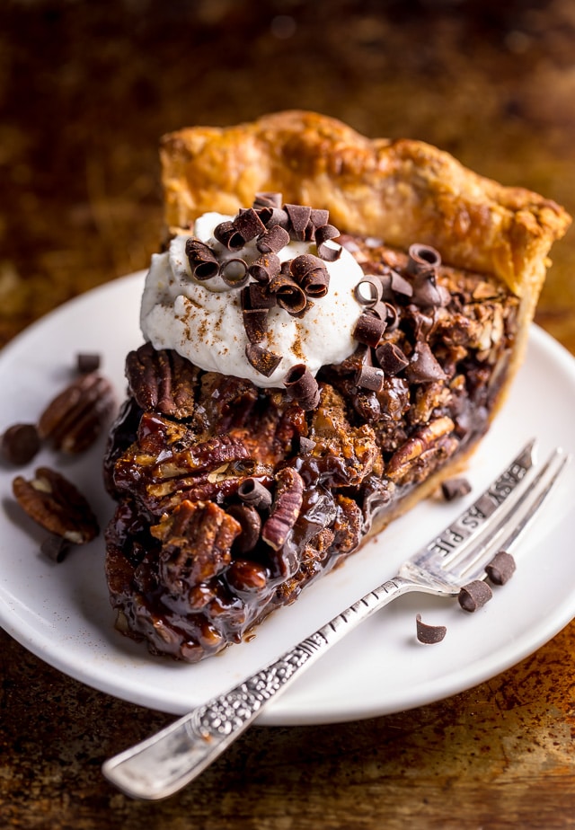 This insanely decadent Chocolate Pecan Pie is topped with a dollop of whipped cream... and extra chocolate, of course!