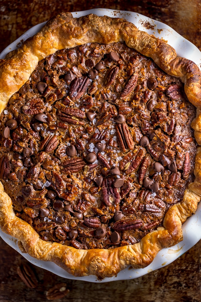 This insanely decadent Chocolate Pecan Pie is topped with a dollop of whipped cream... and extra chocolate, of course!