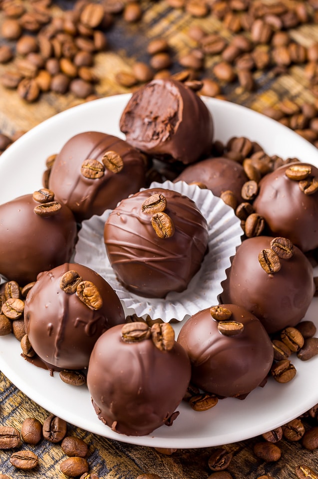 Chocolate truffle beside bulk measuring scoop with cocoa beans on