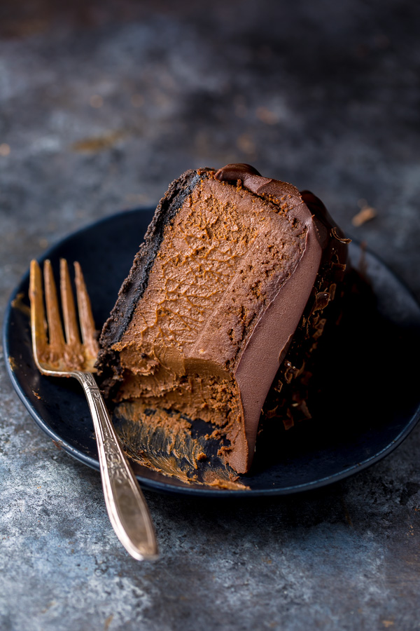 Ultimate Chocolate Cheesecake Slice on black plate. 