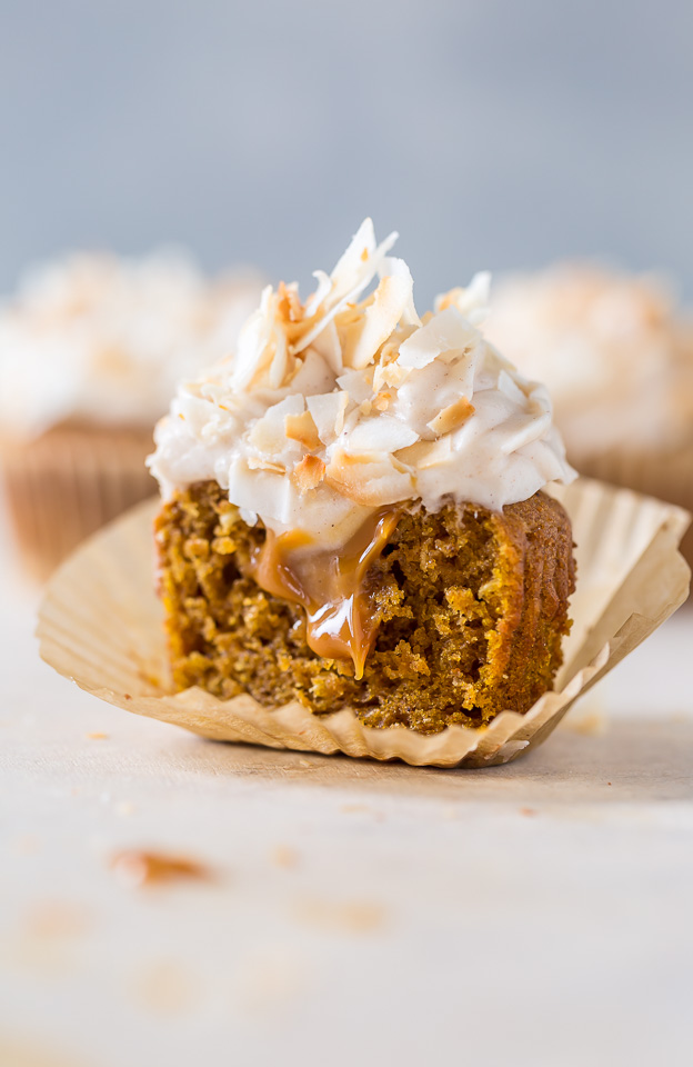 Moist and fluffy Pumpkin Coconut Cupcakes are stuffed with decadent Dulce de Ceche and covered in cinnamon cream cheese frosting! So delicious!