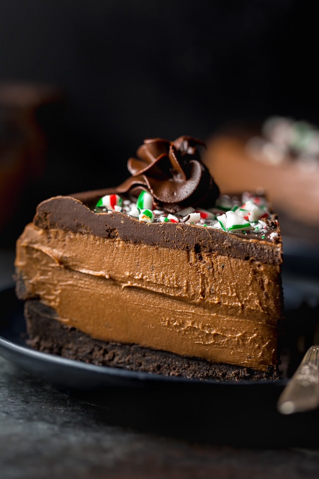 This No-Bake Peppermint Mocha Cheesecake is rich, creamy, and so flavorful! Topped with chocolate ganache and crushed candy canes, this chocolate peppermint cheesecake is seriously festive and perfect for holiday celebrations. #peppermintmocha #cheesecake #chocolate #Christmas #peppermint 