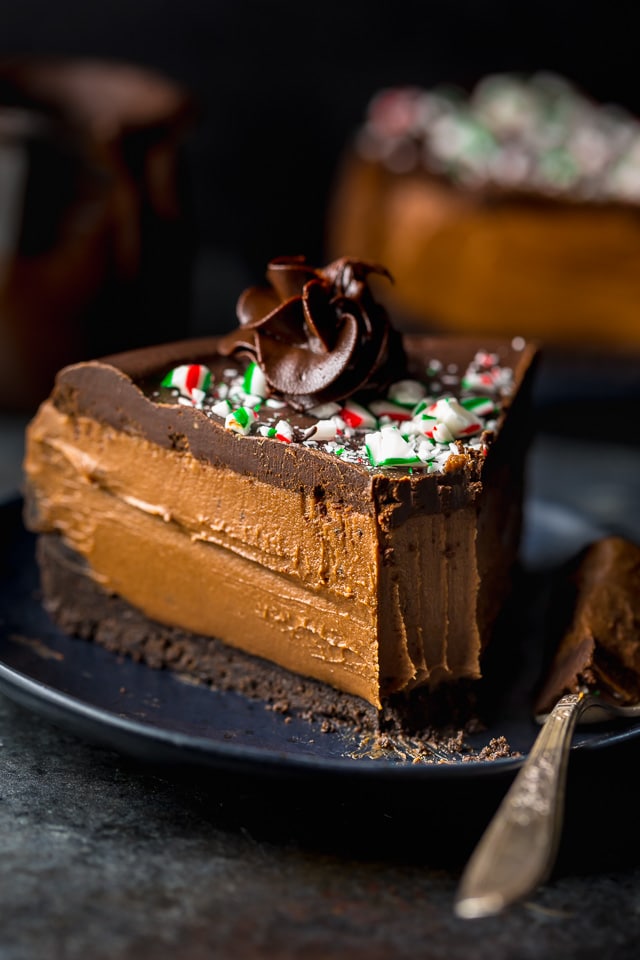 This No-Bake Peppermint Mocha Cheesecake is rich, creamy, and so flavorful! Topped with chocolate ganache and crushed candy canes, this chocolate peppermint cheesecake is seriously festive and perfect for holiday celebrations. #peppermintmocha #cheesecake #chocolate #Christmas #peppermint 