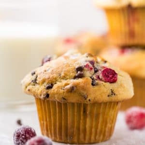 These soft and fluffy Cranberry Banana Muffins are so easy and perfect for breakfast! Full of real banana flavor, fresh cranberries, and a handful of chocolate chips, they're simply irresistible! #cranberry #banana #muffins #breakfast #Christmas #bananamuffins #chocolatechips