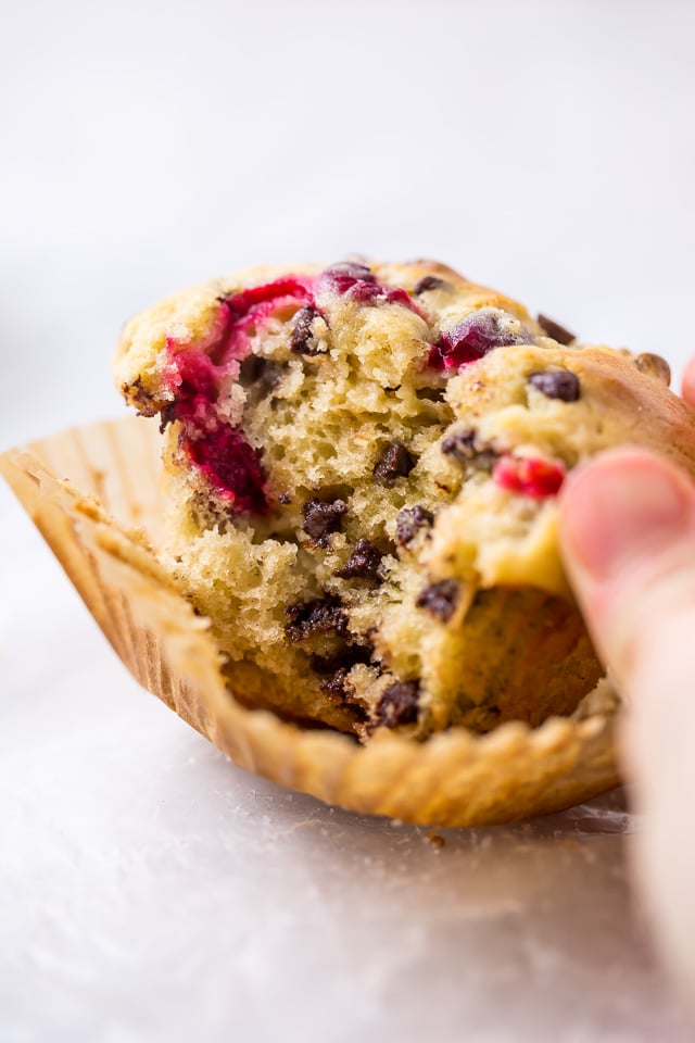 These soft and fluffy Cranberry Banana Muffins are so easy and perfect for breakfast! Full of real banana flavor, fresh cranberries, and a handful of chocolate chips, they're simply irresistible! #cranberry #banana #muffins #breakfast #Christmas #bananamuffins #chocolatechips