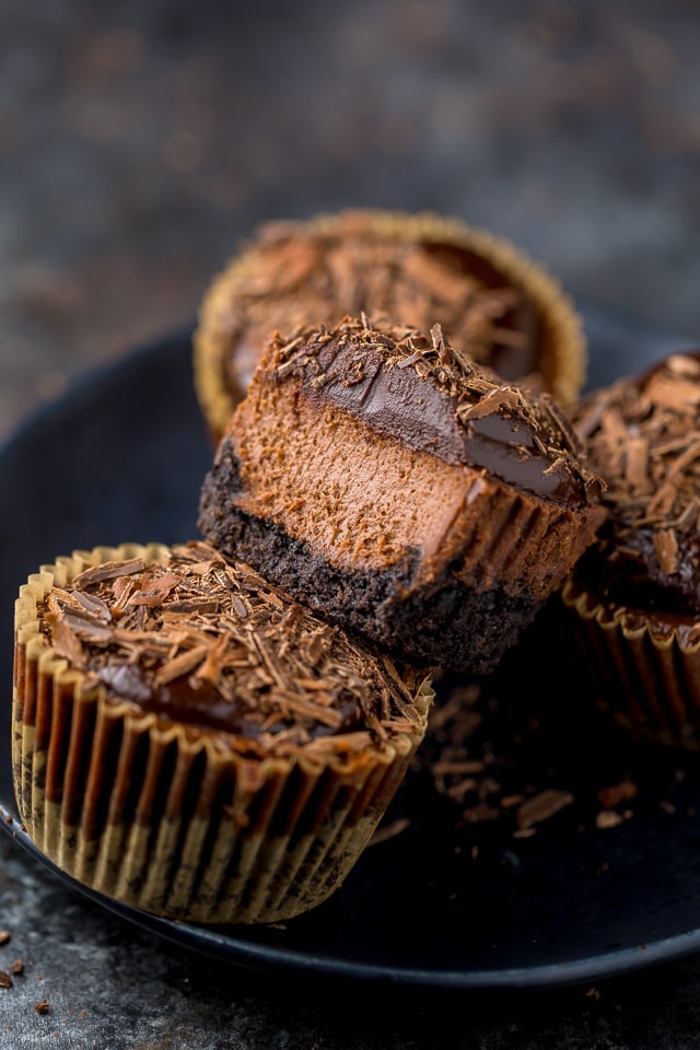 These rich and creamy Mini Chocolate Cheesecakes are made in a muffin pan! So easy and perfect for serving a crowd.