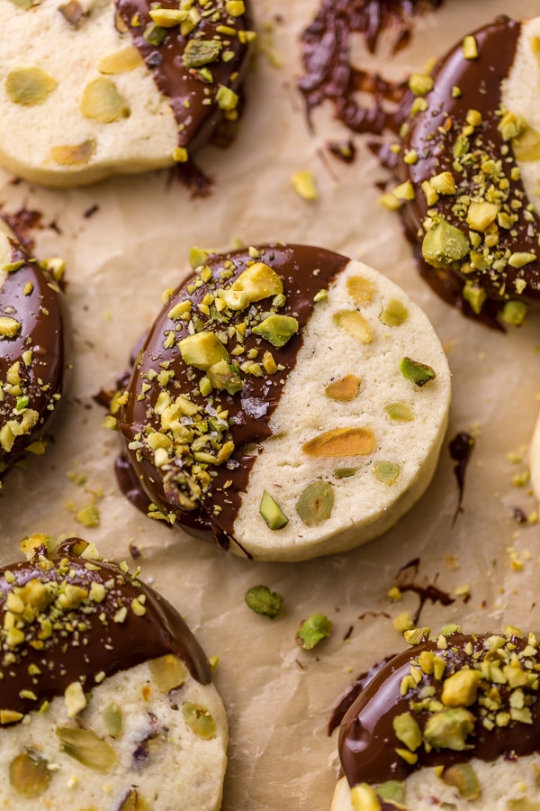 Dark Chocolate Pistachio Slice & Bake Cookies are so easy and made with just 6 ingredients! These buttery shortbread cookies are loaded with pistachios and then dunked in dark chocolate. So good with a cup of coffee or tea! 